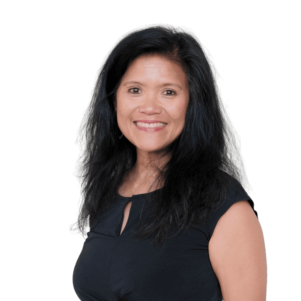 A woman with long black hair, wearing a black short-sleeve top, smiles at the camera against a plain white background.
