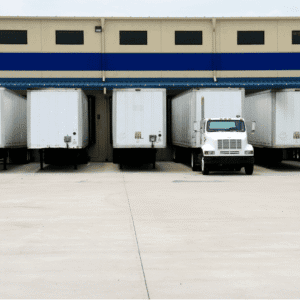 Five semi-trailers docked at a warehouse loading bay for trade spend operations.